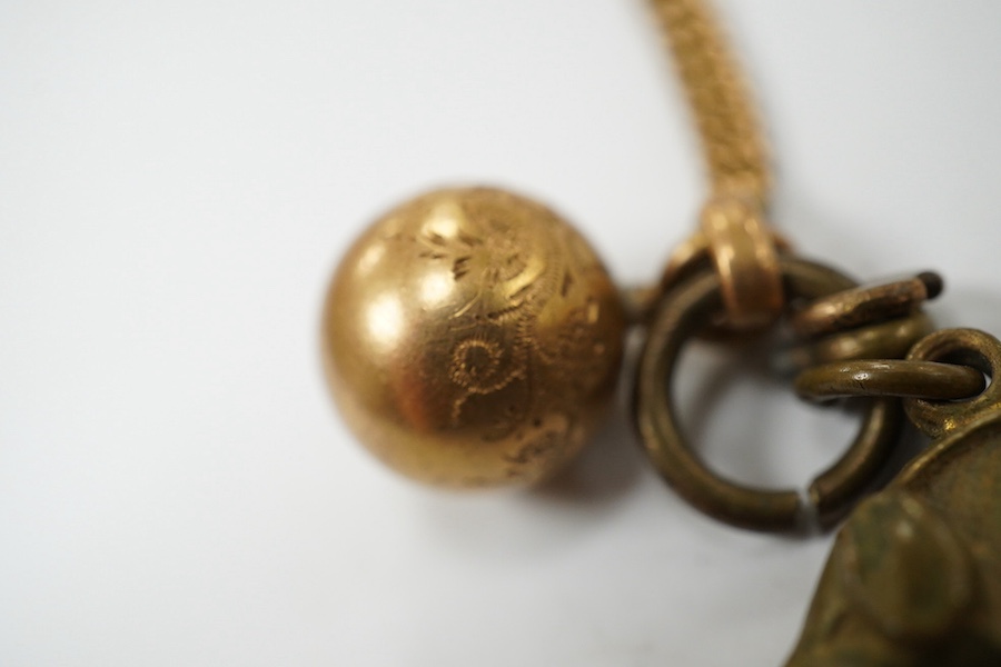 A Victorian yellow metal oval locket, with rope twist band, overall 29mm and a yellow metal fob chain. Condition - fair